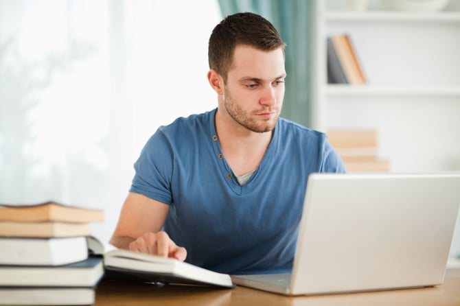 Male student researching material on the internet